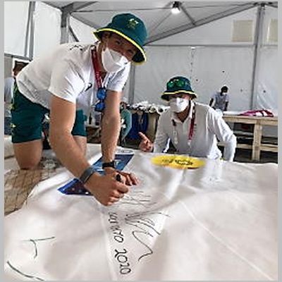 2020 Gold medal AUS WEARN Matt siging his sail with his coach Michael (hat-tric  3 golds in a raw).jpg